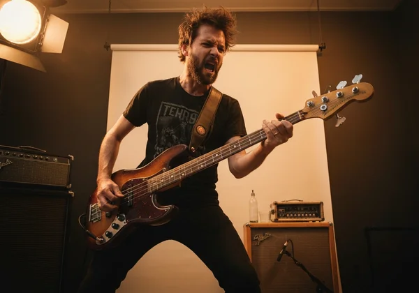 Frustrated bass player tuning a low E string